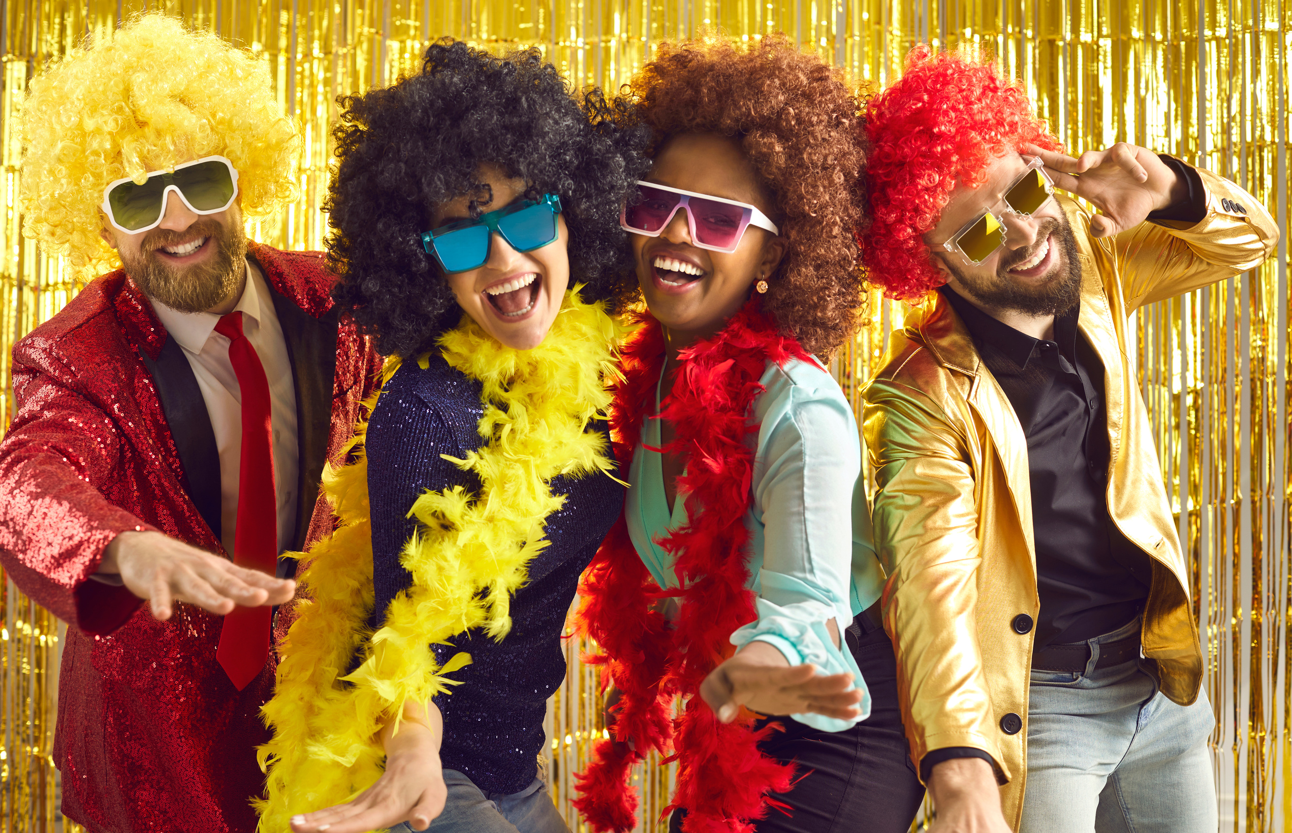 Group of Happy People in Boas and Curly Wigs Dancing and Having Fun at Disco Party